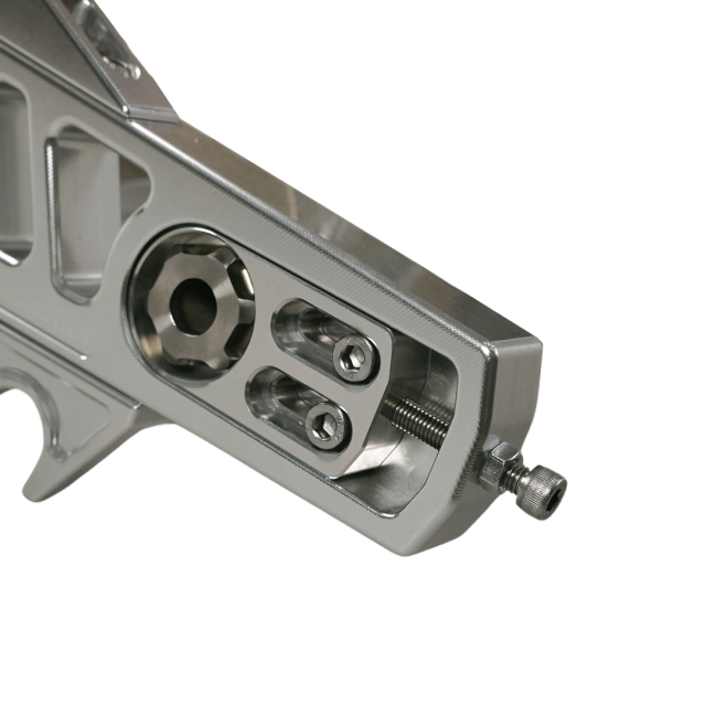 Close-up of Billet V1 Swingarm (Softail 2018+) axle adjuster area, highlighting detailed machining and high-performance hardware.
